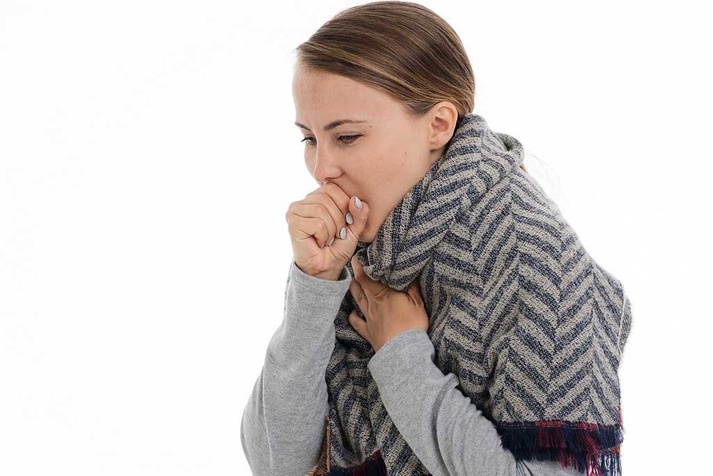Woman coughing from toxic fumes