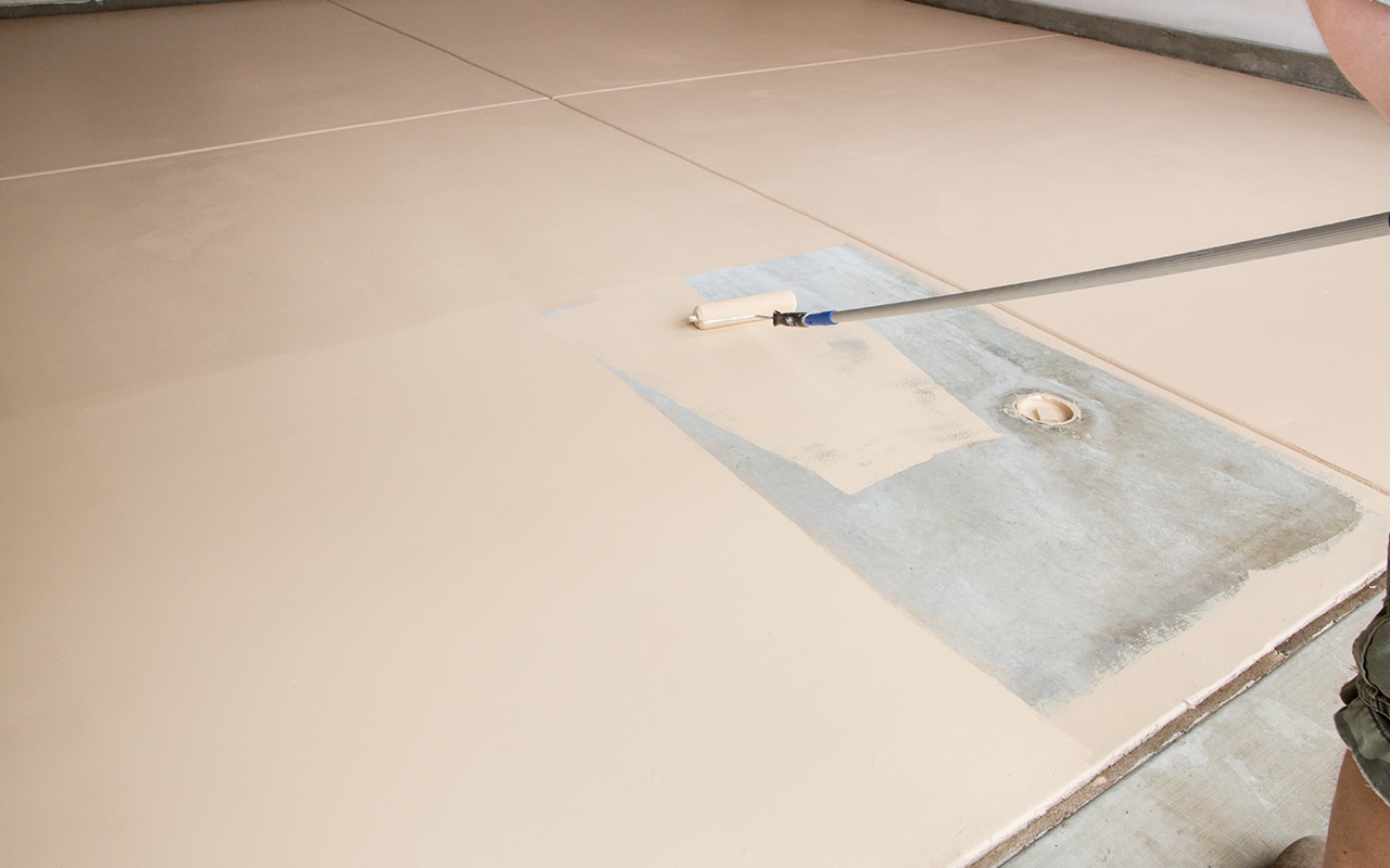 paint roller painting garage floor